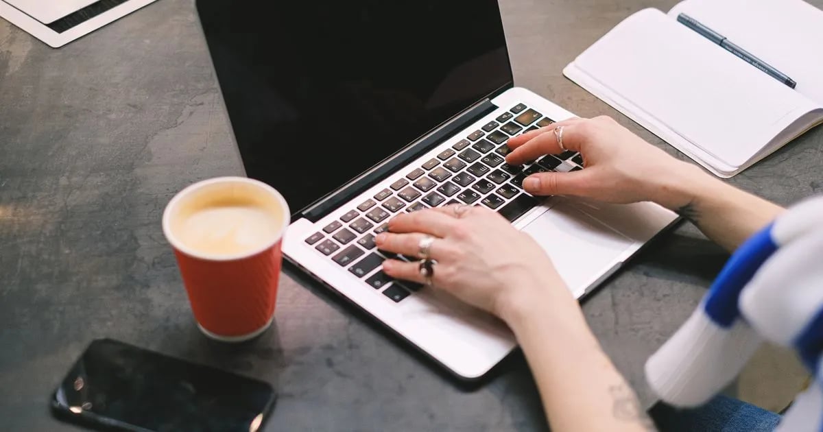 Freelancer working on a laptop with a coffee